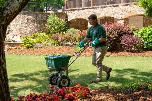 pro turf bennington lawn tech spreading fertilizer solution on lawn